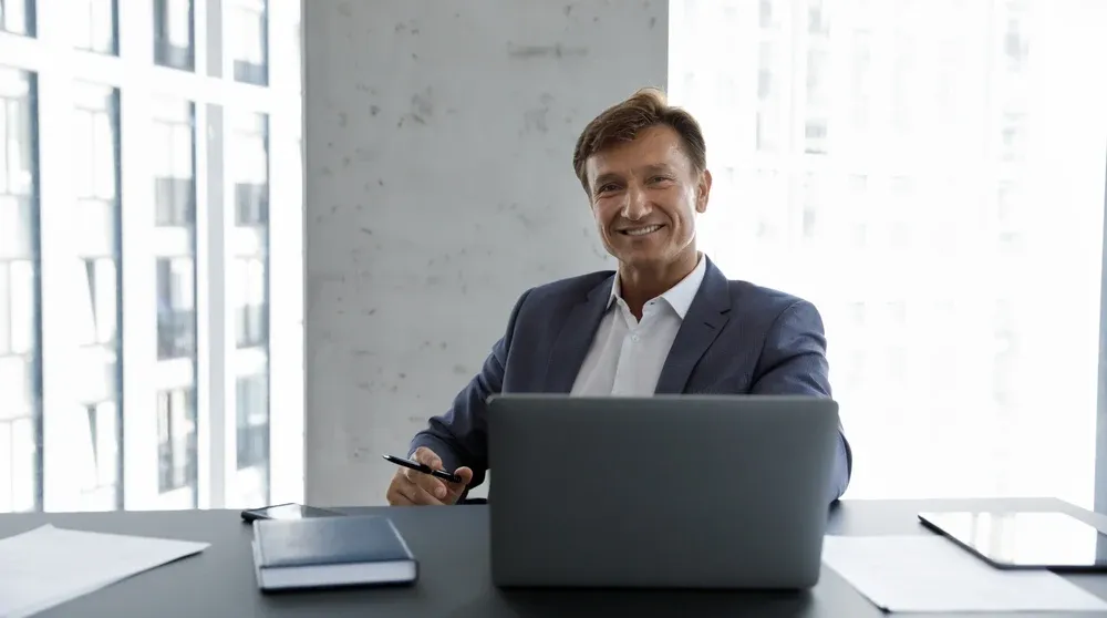 Business owner working at a computer in a professional office representing NAP consistency local SEO audit process