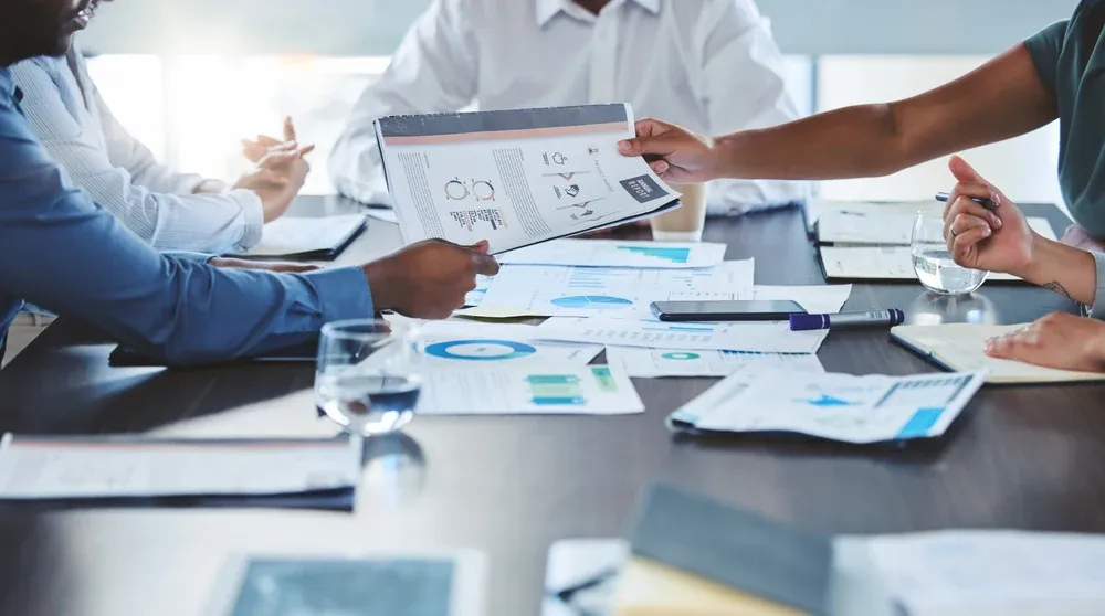 Team reviewing analytics reports at a modern office desk representing local SEO audit action planning