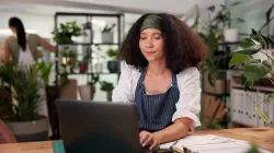 Small business owner working on laptop reviewing local SEO strategy