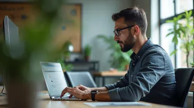 Business consultant managing directory submissions and citations on laptop