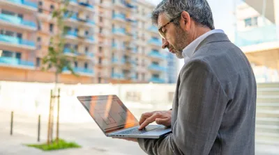 Business professional reviewing backlink strategy on laptop for local SEO